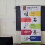 Poster/banner for Wydział Włókiennictwa i Wzornictwa Politechniki Łódzkiej on a classroom wall.