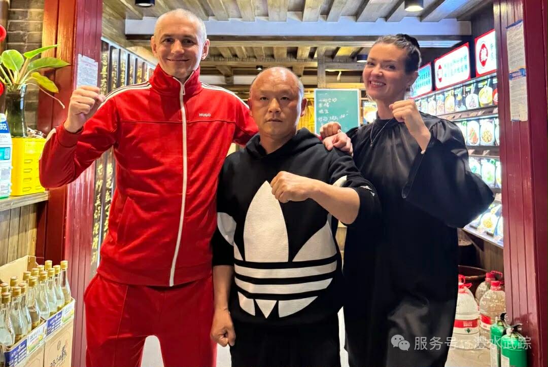 Three people posing with fists up in a store, smiling at the camera.