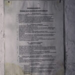 Polish instruction poster titled 'INSTRUKCJA OGÓLNA' on a weathered wall, detailing cleaning procedures for mills in numbered sections.